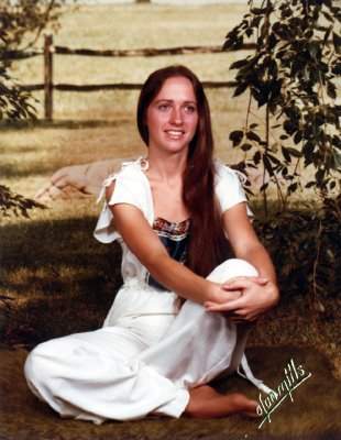 Olan Mills backdrop #4: Bucolic Meadow with Split Rail Fence. Is that an animal carcass behind her? 